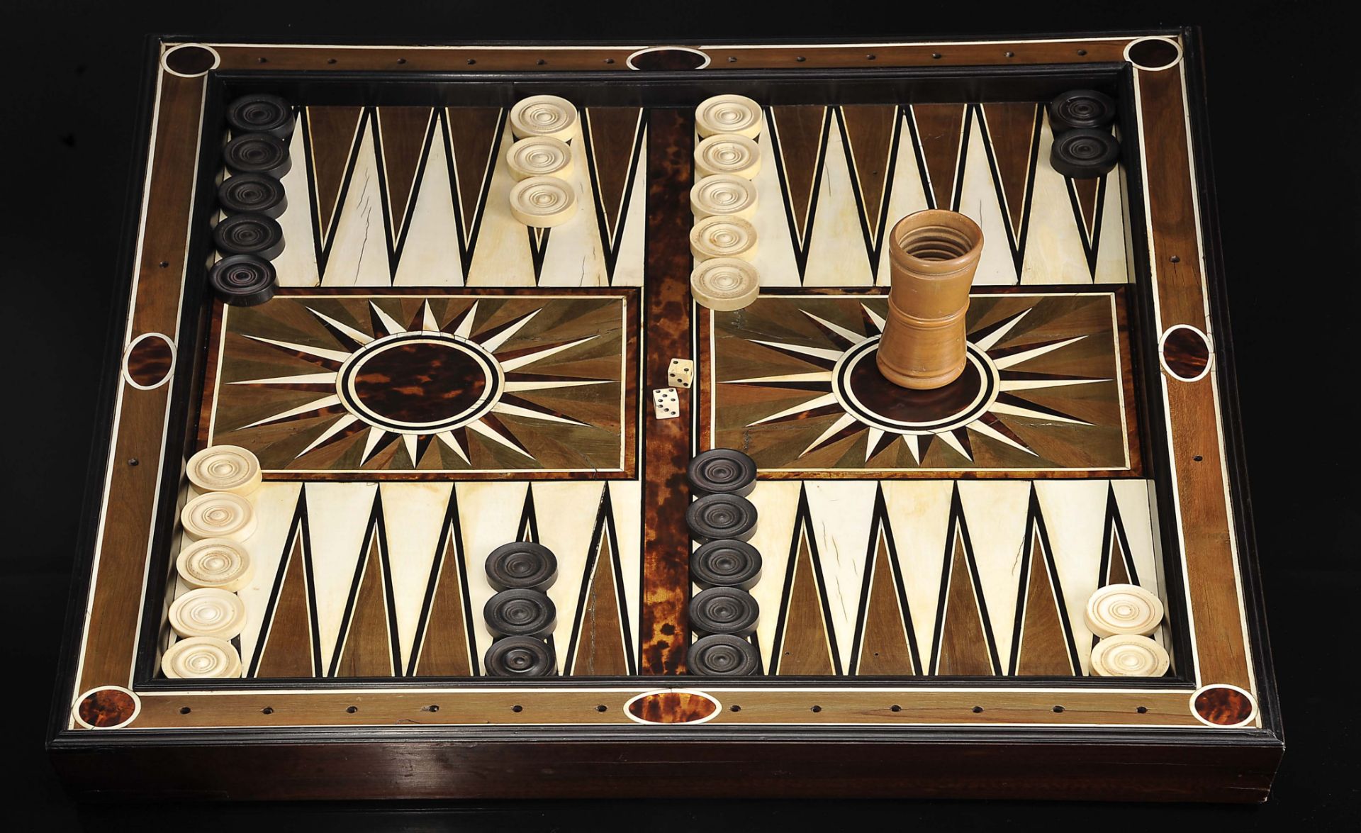 Chess and Backgammon board with backgammon pieces, two dice and cup