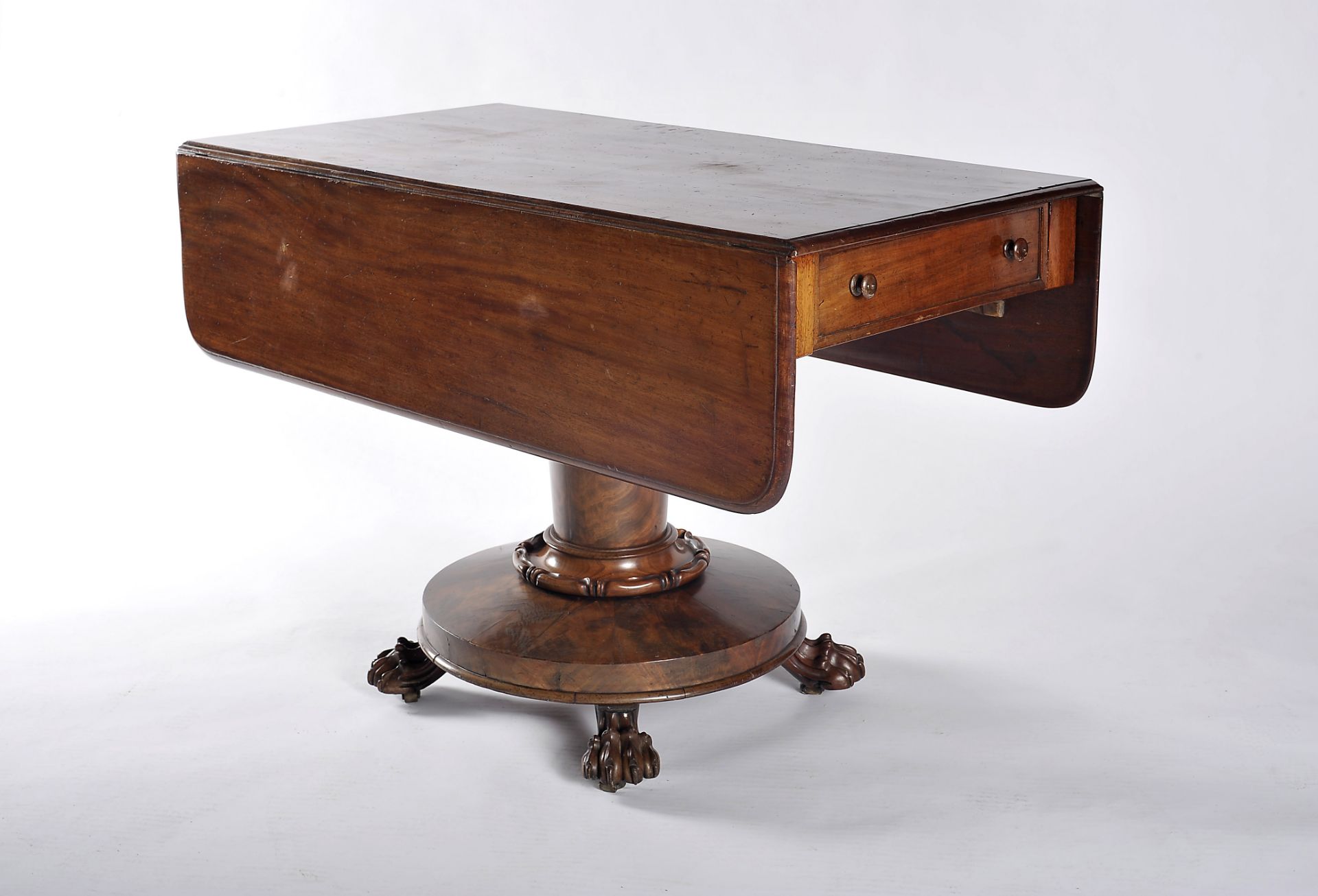 A drop leaf table with drawer