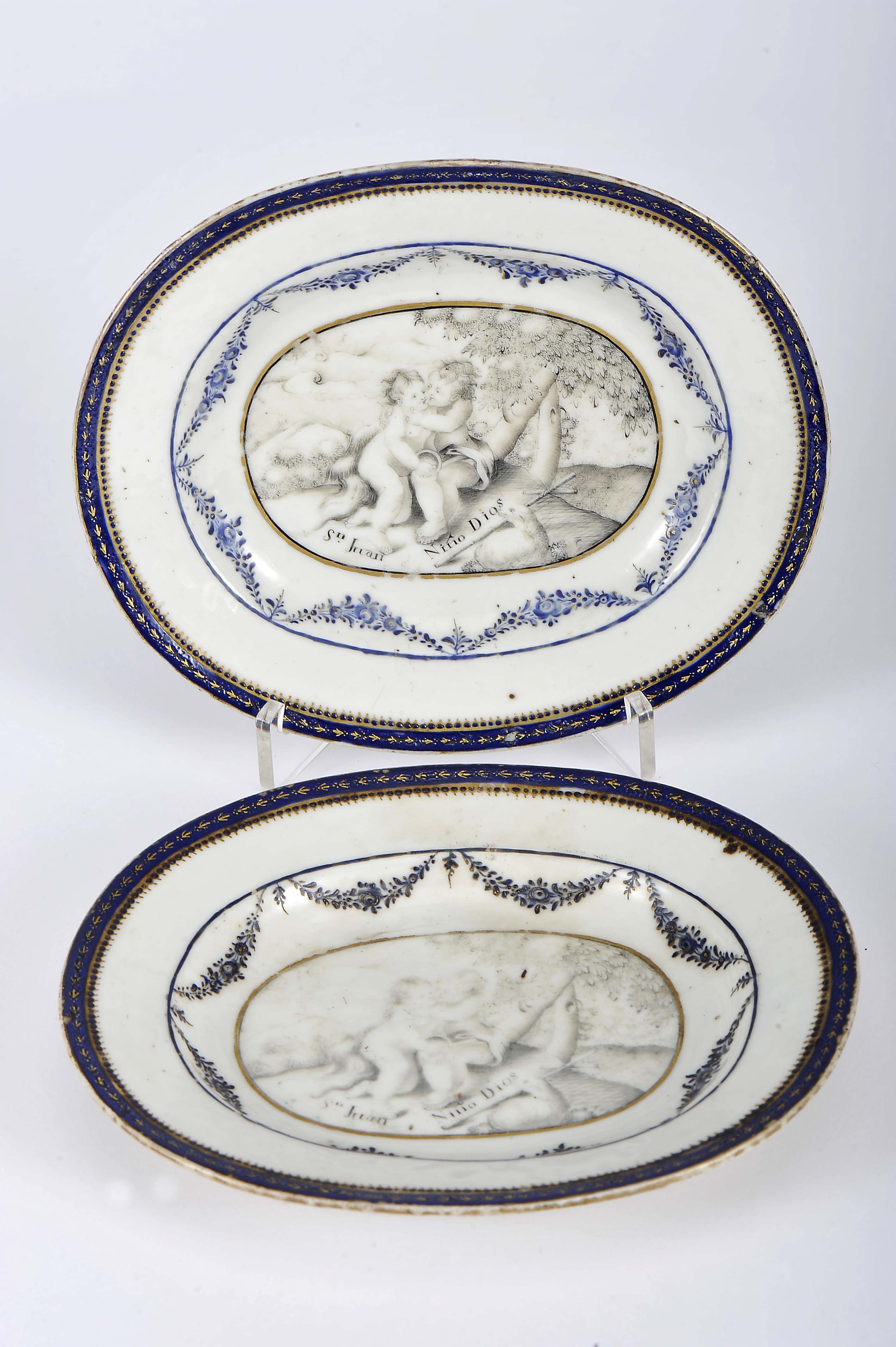 A pair of oval butter stands