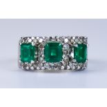 An Emerald and Diamond Ring, Modern, 18ct gold set with three empress cut emeralds, each