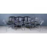 After Harry Bertoia (1915-1978) - A Pair of Chrome Metal Mesh Easy Chairs, with black vinyl seat