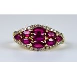 A Ruby and Diamond Ring, Modern, 14ct gold set with nine faceted ruby stones, approximately 2ct