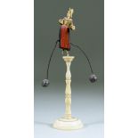 I* A Carved Wood and Bone Balance Toy, 19th Century, depicting a dancer balanced on one toe, with