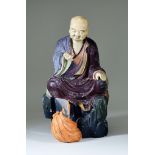 I* A Chinese Carved Ivory and Painted Wood Seated Figure of a Lohan, his right hand raised 15.