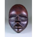 A Dan Mask, Ivory Coast, with stained finish, second half of 20th Century, 13.75ins