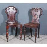 Two Early Victorian Mahogany Hall Chairs, the shaped backs with leaf and scroll carving, one on