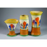 Crocus, Three Clarice Cliff Bizarre Vases, painted in colours between yellow and brown bands, vase