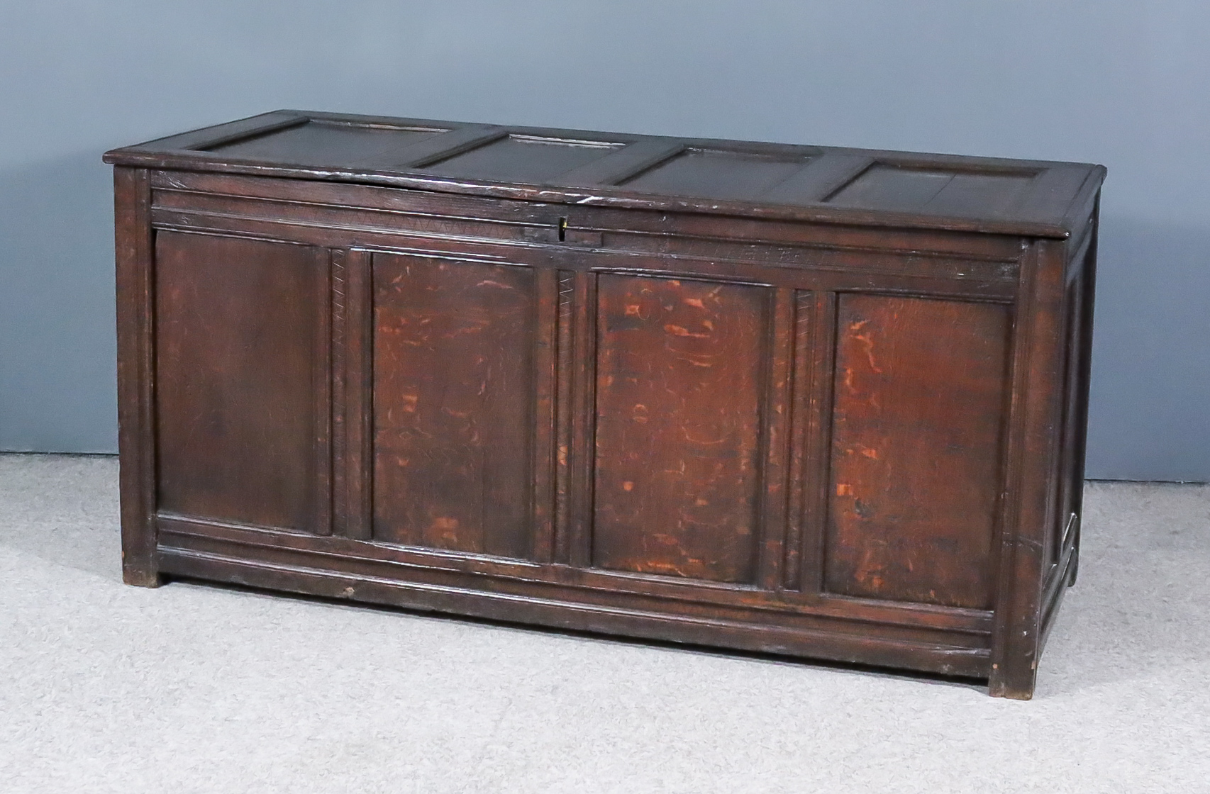 A Late 17th Century Panelled Oak Coffer, with four panelled lid and front, the whole with moulded