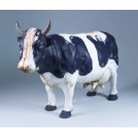A Black and White Painted Cast Iron Cow, 20th Century, 11ins high