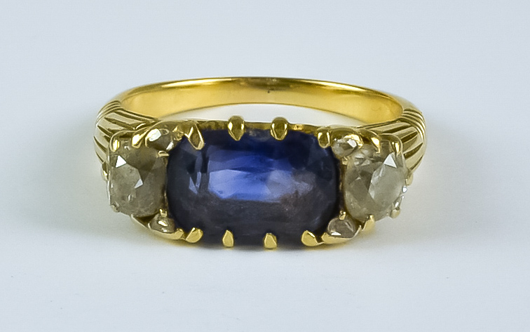A Sapphire and Diamond Three Stone Ring, 20th Century, 18ct gold set with a centre oblong