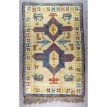 A Mid 20th Century Anatolian Rug woven in muted colours with two stylised cross medallions, the