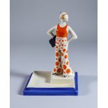 Lido Lady, a Clarice Cliff Bizarre Ashtray, shape no. 561, modelled as a standing lady with her