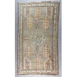 A Mid 20th Century Anatolian Runner woven in muted colours with a central stylised cross medallion
