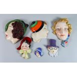 A Czechoslovakian Pottery Female Head Pattern Wall Plaque and Ten Others, the head with wavy
