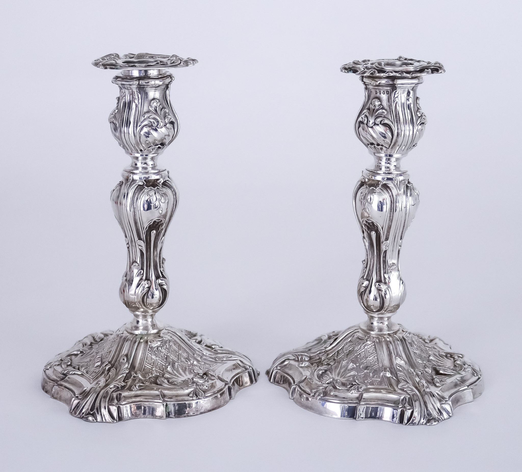 A Pair of Victorian Silver Pillar Candlesticks of Rococo Design, with import mark for J G London