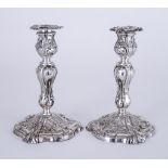A Pair of Victorian Silver Pillar Candlesticks of Rococo Design, with import mark for J G London