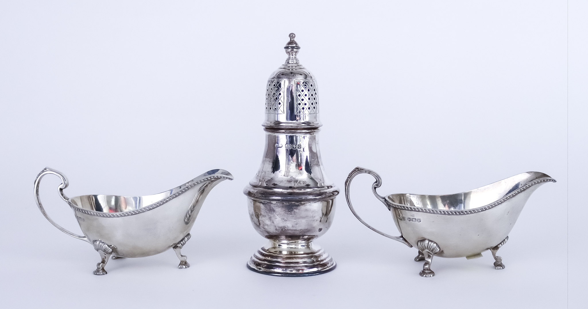 A Pair of Elizabeth II Silver Oval Sauce Boats and a Sugar Caster, the sauce boats by Cooper