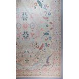 A Mid 20th Century Large Anatolian Carpet woven muted colours, the field filled with trailing leaf