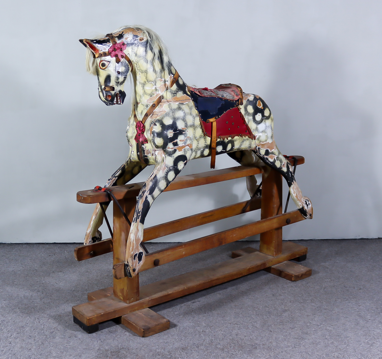 An Early 20th Century Dapple Grey Painted Rocking Horse, by Collinson, on pine stand, 55ins wide x
