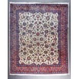 An Early 20th Century Fine Sarough Carpet woven in colours of wine, navy blue and ivory, the field