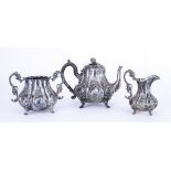A 19th Century Indian Silvery Metal Three-piece Tea Service, of baluster panelled form embossed with