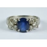 A Sapphire and Diamond Ring, Modern, 18ct white gold set with a centre sapphire approximately 1.5ct,