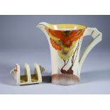 Rhodanthe, a Clarice Cliff Daffodil Jug and a Bizarre Daffodil Two-Division Toast Rack, painted in