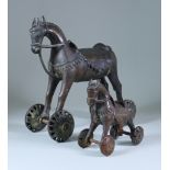 Two Indian Bronze Temple Toy Horses, each on wheels 12ins (30,5cm) high and 6.25ins (15.8cm) high