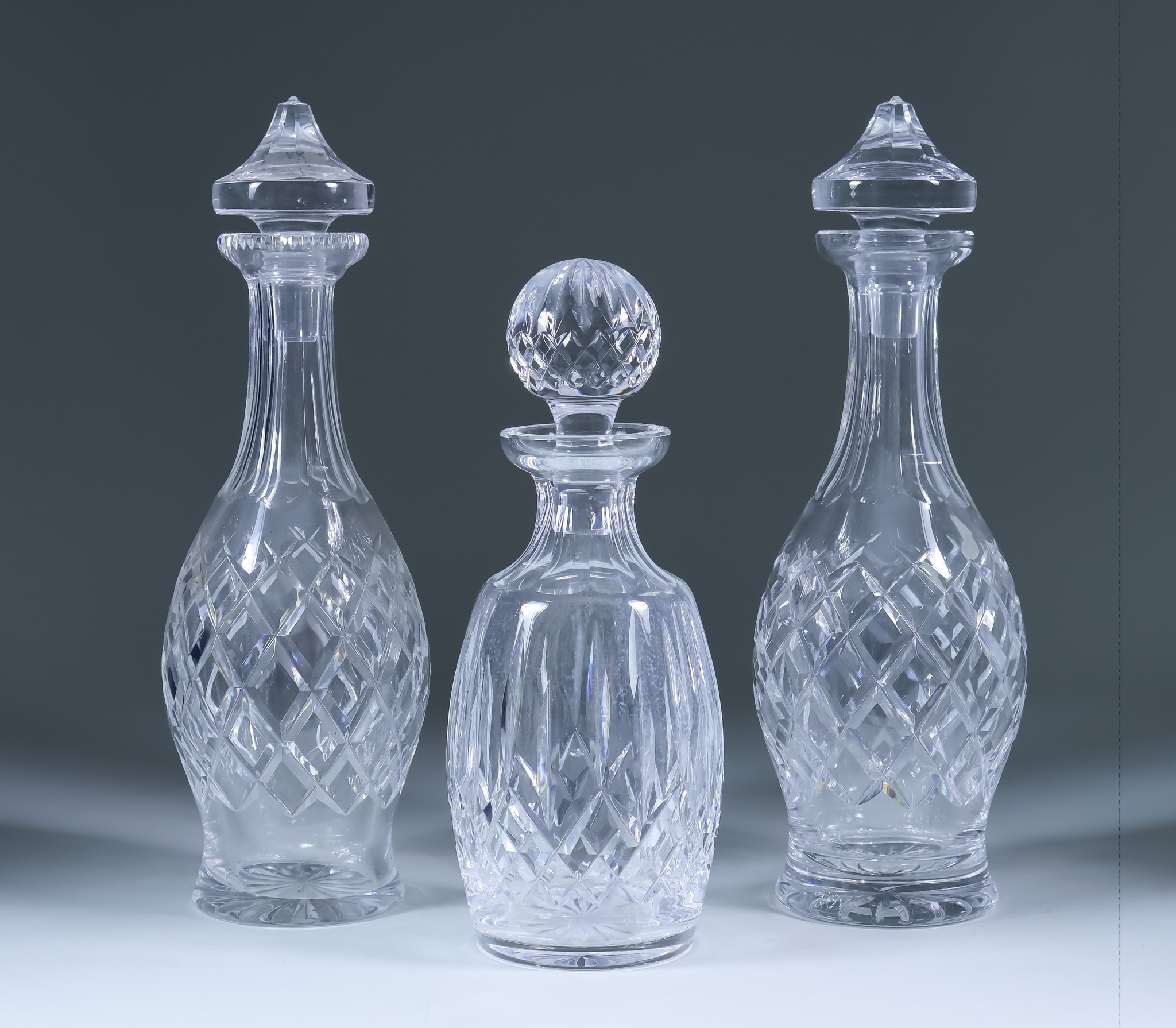 Two Waterford Wine Decanters and Stoppers of Boyne Pattern, 13ins high, and a Lismore spirit