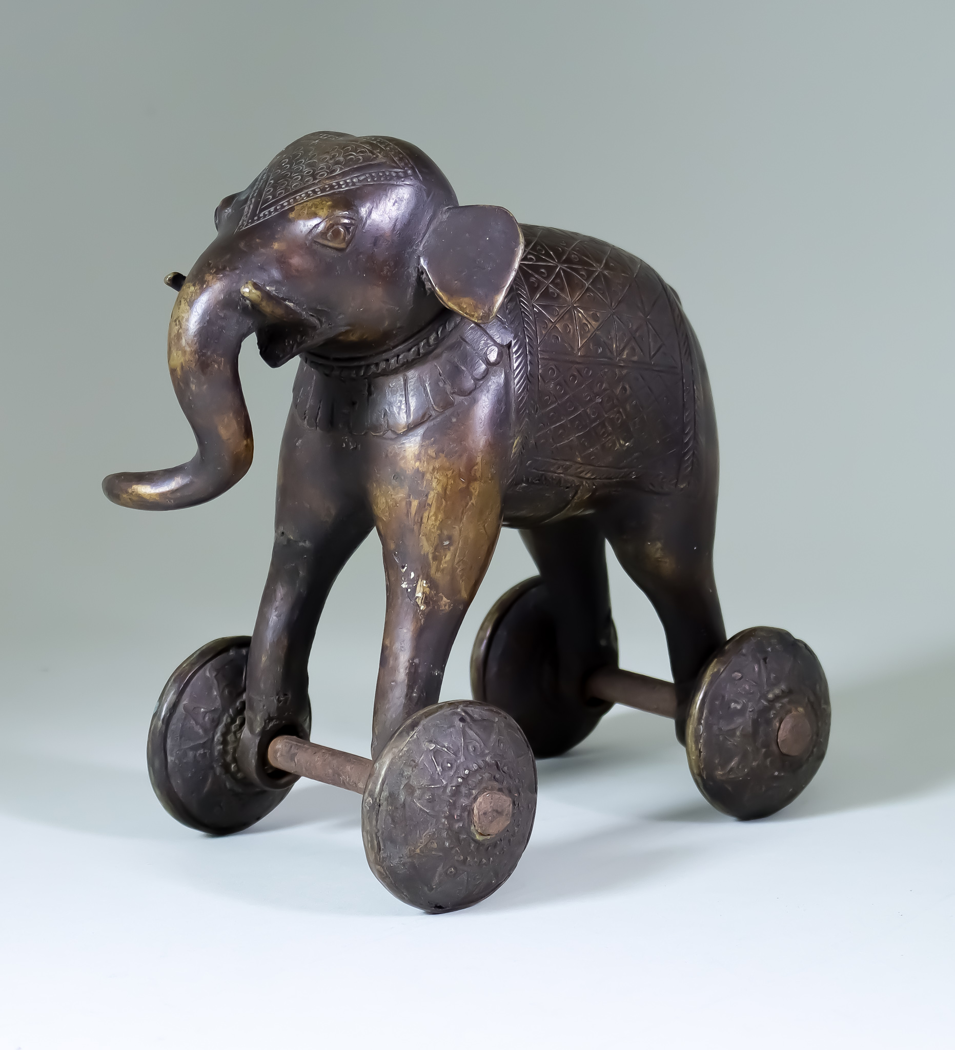 An Indian Bronze Temple Toy Elephant, on wheels 8ins (20.3cm) high