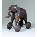 An Indian Bronze Temple Toy Elephant, on wheels 8ins (20.3cm) high