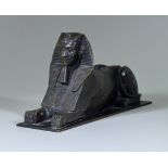 A Brown Patinated Bronze Model of a Sphinx, on rectangular base 11ins overall x 5.75ins high