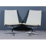 After Charles Eames (1907-1978) - A Pair of Chrome Framed Swivel Chairs, upholstered in cream