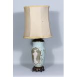 A French Pate-Sur-Pate Celadon Porcelain Gilt-Metal Mounted Oil Lamp, decorated with a Geisha