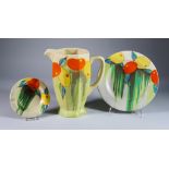 Delecia, a Clarice Cliff Bizarre Coronet Jug, a Plate and an Ashtray, all painted in colours, the