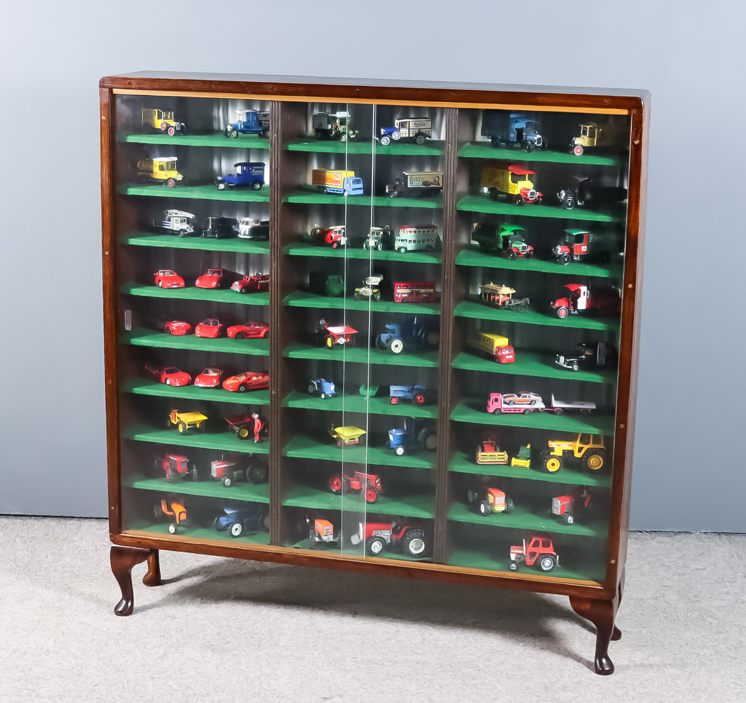 An Oak Glass Fronted Display Cabinet containing Fifty-Nine Assorted Model Cars, various makes and