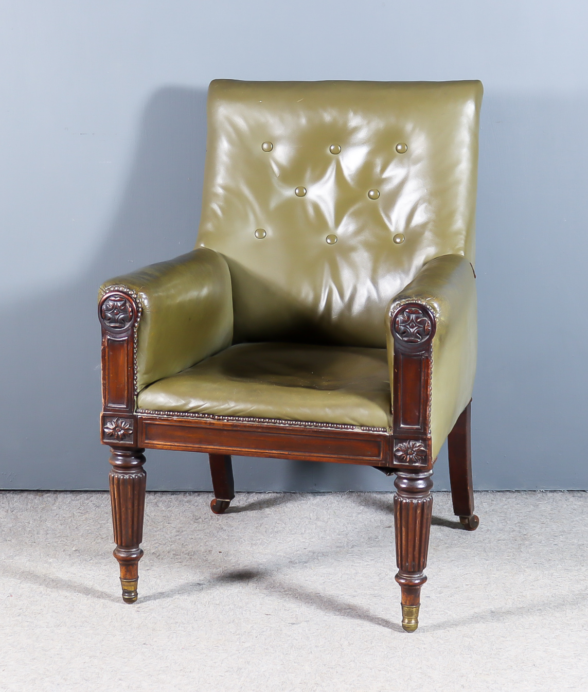 A William IV Mahogany Library Framed Armchair, with square back upholstered in green leather, the