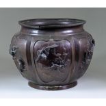 A Japanese Patinated Bronze Jardiniere, of lobed outline, with seven panels cast with birds and