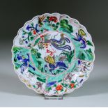 A Chinese Kangxi Famille Verte Porcelain Dish with shaped rim, enamelled with fabled creatures, blue