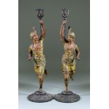 A Pair of Continental Cold Painted Spelter Candlesticks, Late 19th Century, modelled as running male