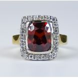 A Garnet and Diamond Ring, Modern, 14ct gold set with a centre faceted garnet, approximately 2ct,