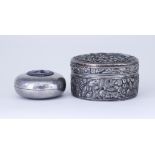 A Chinese Silvery Metal Circular Box and Cover and a Smaller White Metal and Enamel Circular Box and