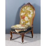 A Victorian Walnut Framed Spoonback Nursing Chair, with moulded frame, upholstered in floral