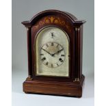 An Early 20th Century Mahogany Cased Mantel Clock, the 5.75ins arched dial with Roman numerals and