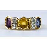 A Coloured Sapphire and Diamond Ring, Modern, yellow metal set with three faceted sapphires, of