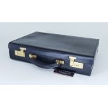A Black Leather Attaché Case by Simpson of London, 17ins x 12ins, with original tag