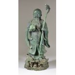 A Chinese Bronze Figure of Shou-Lao, Daoist God of Longevity, holding a dragon staff and peach, 19.