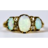 An Opal and Sapphire Ring, 20th Century, 18ct gold set with three opals inter spaced with four small