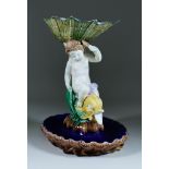 An English Maiolica Putto and Dolphin Centrepiece, Circa 1870, the putto supporting a shell dish,