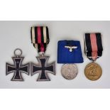 Four German Medals, comprising - two German Iron Crosses, one World War I, the other World War II, a